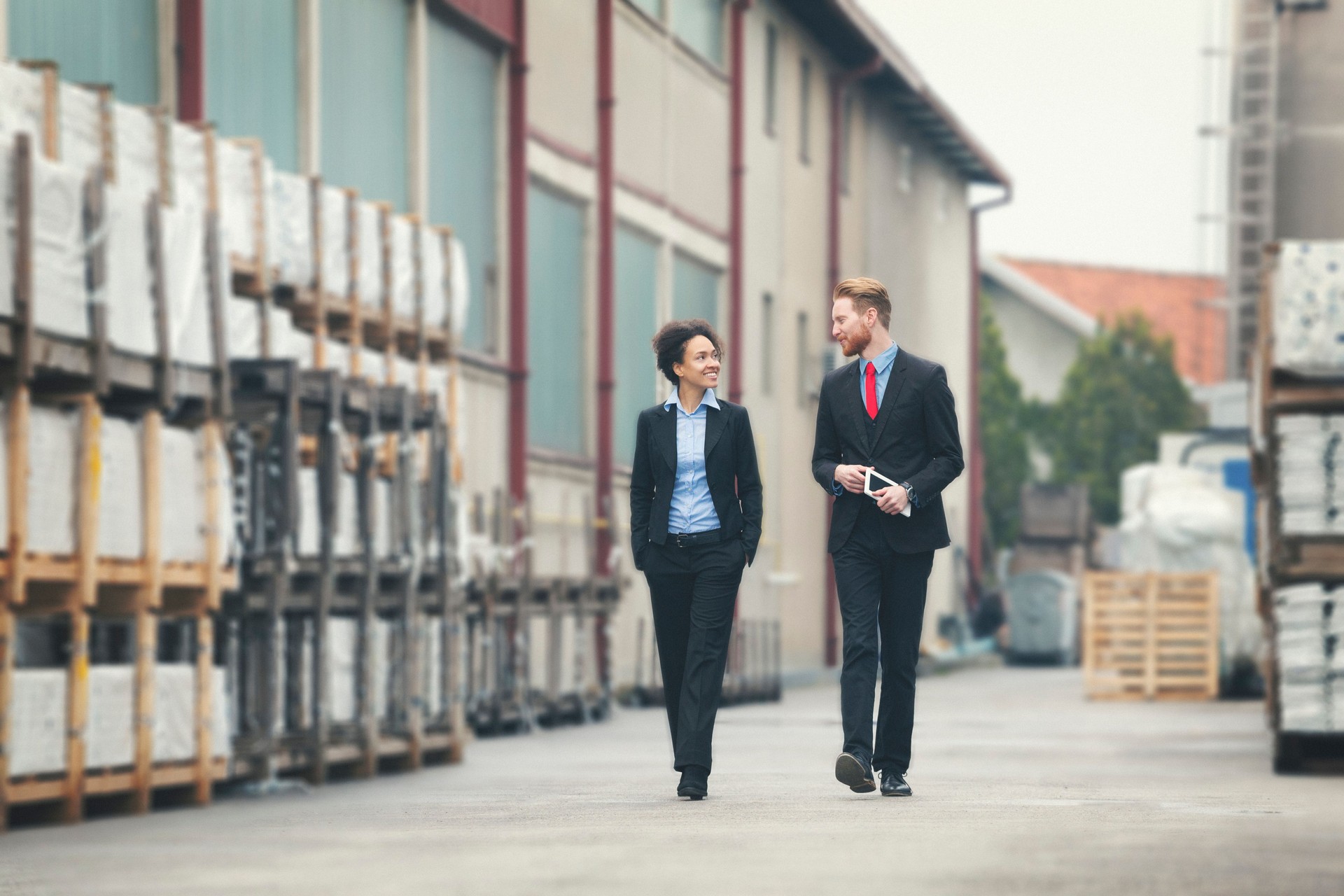 Two businessman walking trough storagehouse
